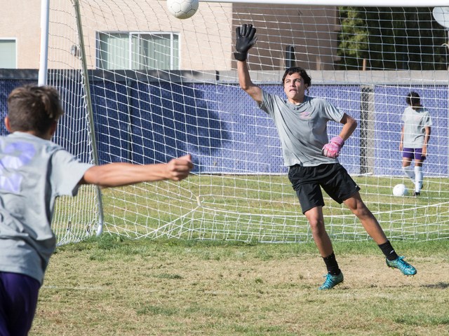 Paolo Sarnataro (23), right, goes up for a ball after Oscar Rodriguez (12) kicks it during s ...