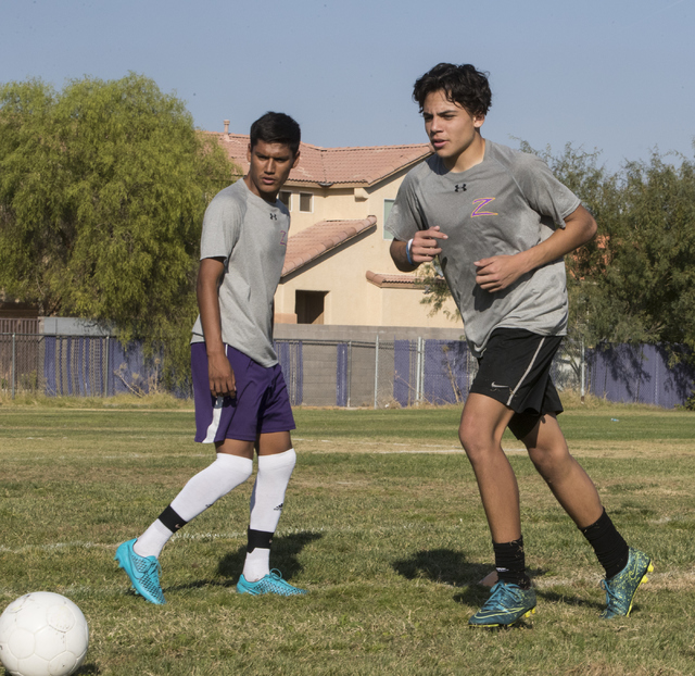 Paolo Sarnataro (23), right, and Marcos Delangel-Parra (4) run drills during soccer practice ...