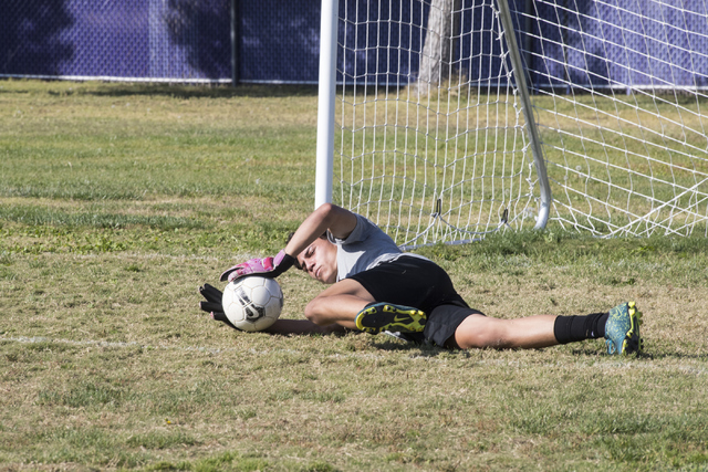 Paolo Sarnataro (23) dives for a ball during soccer practice at Durango High School in Las V ...