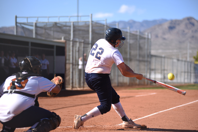 Shadow Ridge’s Kate Dennis (22) hits a pitch against Legacy during their softball game ...