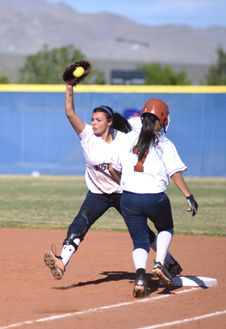 Shadow Ridge’s Justin Garganese (24) catches the ball for an out at first base against ...