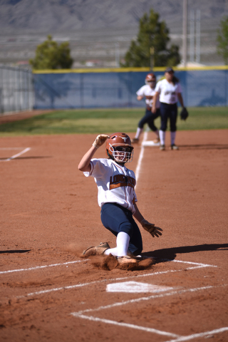 Legacy’s Kellie Nelson (1) slides into home, but was called out on a force out against ...