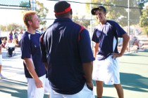 Liberty tennis players Dylan Ihmels, right, and Tristan Hoyle talk with coach Kih Gourrier a ...