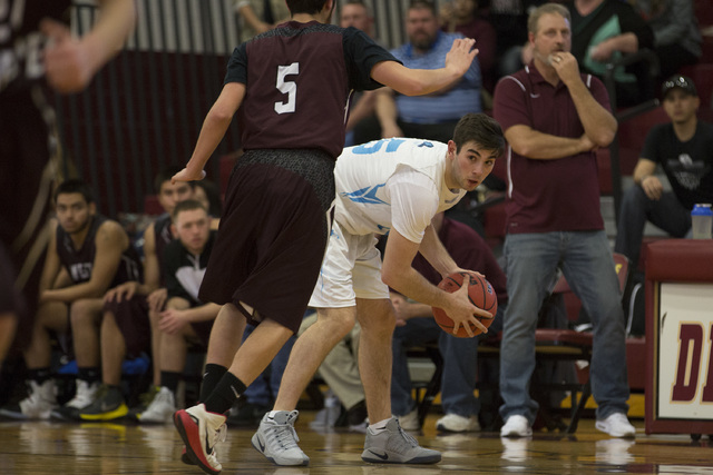 Adelson senior Jake Buchman looks for a teammate to pass to during the 2A boys state semifin ...