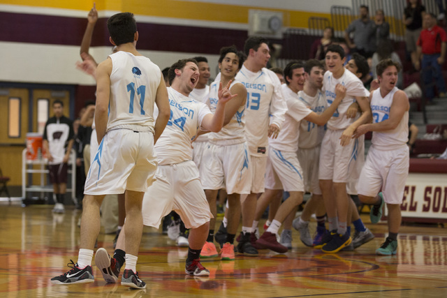 Adelson boys basketball team celebrates their win, after going into overtime, against West W ...