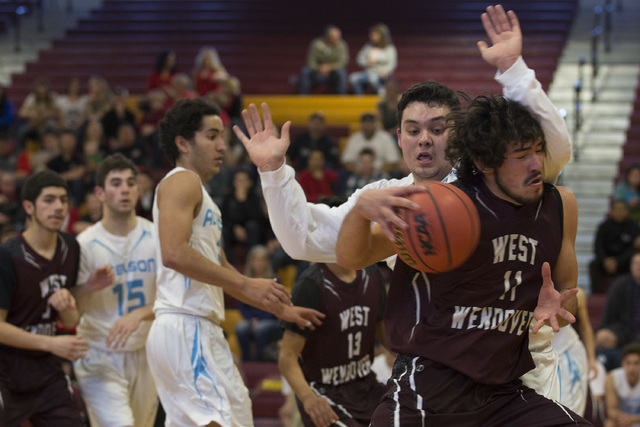 Adelson senior Brandon Pappas attempts to guard West Wendover senior Zade Elton as he goes u ...