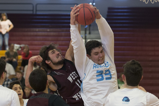 Adelson senior Brandon Pappas gets West Wendover’s rebound during the 2A boys state se ...