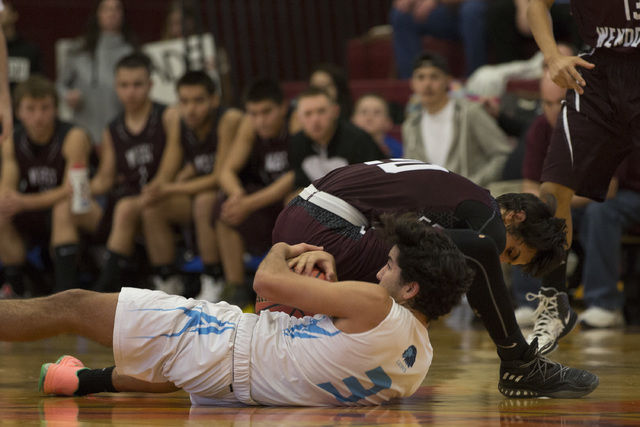 West Wendover junior Saul Palacios, right, looses possession of the ball to Adelson senior J ...