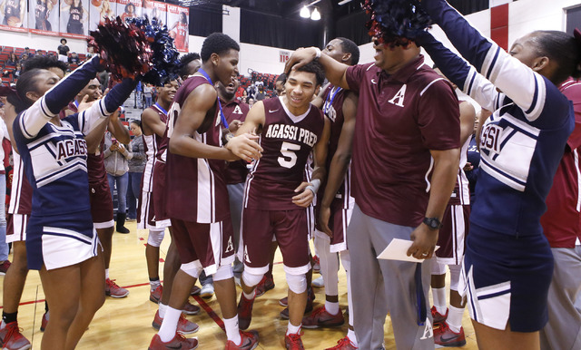 Agassi Prep’s Allen Merritt (5) is cheered by teammates and coaches as he accept a med ...