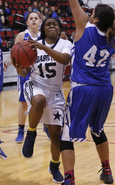 Agassi Prep’s Denise Parker (15) shoots as Needle’s Jayne Antone (42) blocks du ...