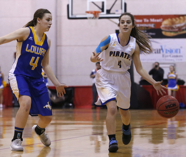 Moapa Valley’s Matilda Thompson (4) drives the ball pass Lowry’s Sydney Connors ...