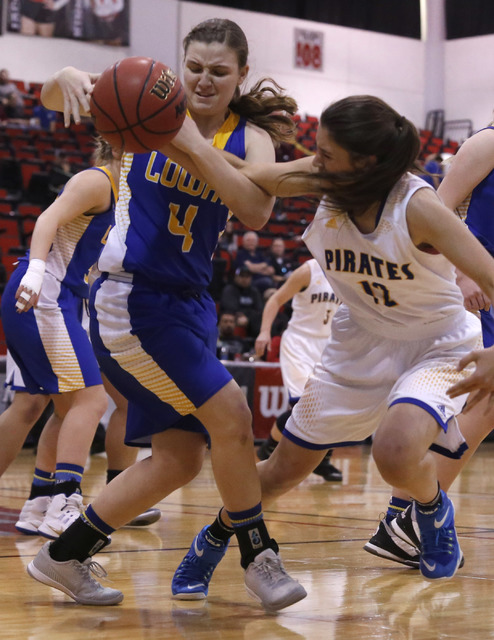 Lowry’s Broklyn Backus (12) and Moapa Valley’s Madison Bush (12) struggle for a ...