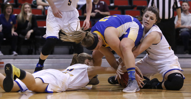 Lowry’s Alyssa Kuskie (3), center, struggles for a loose ball from Moapa Valley player ...