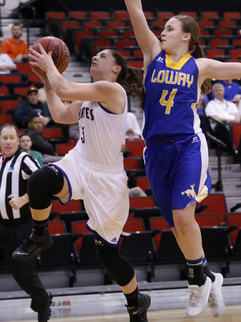 Moapa Valley’s Lainey Cornwall (3) shoots on Lowry’s Sydney Connors (4) during t ...