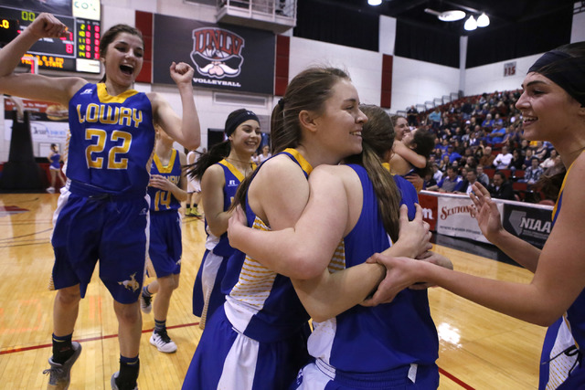 Lowry players celebrate after winning a Class 3A girls state semifinal game against Moapa Va ...