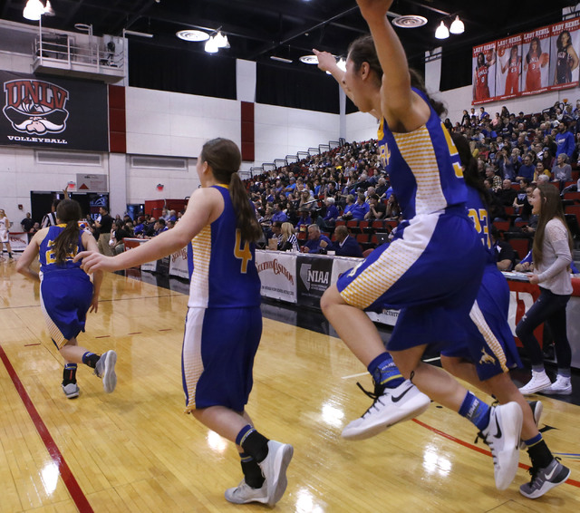 Lowry players celebrate after winning a Class 3A girls state semifinal game against Moapa Va ...