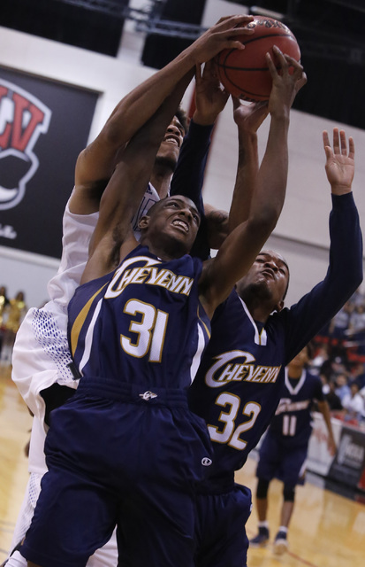 Cheyenne’s Hahsonie Laushaul (31) and Cheyenne’s Damion Bonty (32) struggle to k ...