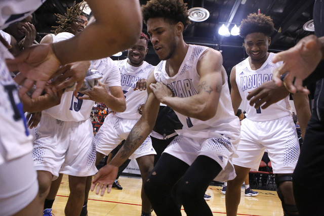 Cheyenne’s Marcus Greer (3) dances as his teammates cheer him on after winning a Class ...