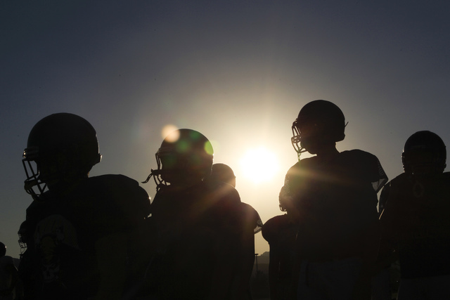 Moapa Valley High School football players prepare for practice at the school in Overton, Nev ...