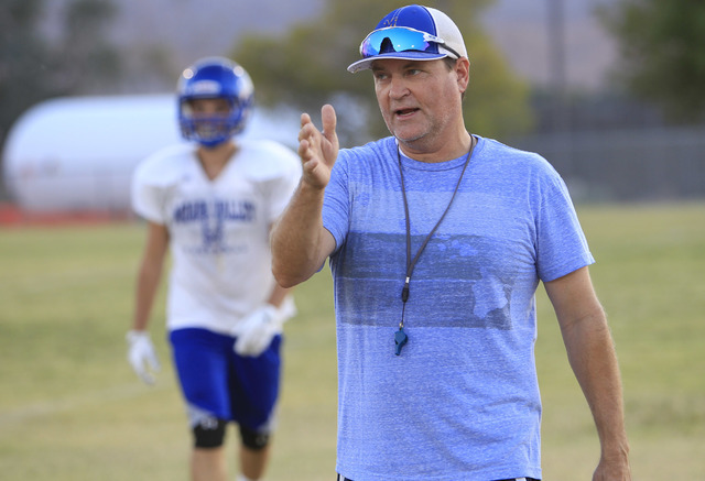 Moapa Valley High School football coach Brent Lewis instructs his team during team practice ...