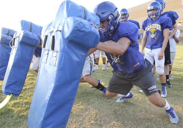 Moapa Valley High School center Cameron Larsen does a drill during team practice in at the s ...