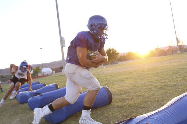 Moapa Valley High School fullback Dalyn Leavitt runs the ball on a drill during team practic ...