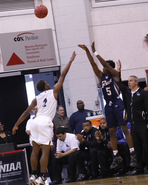 Cheyenne’s Kavon Williams (5) shoots on Desert Pines’ Jordan Simon (2) during th ...