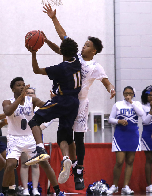 Cheyenne’s Ke’Shawn Hall (11) shoots as Desert Pine’s Capri Uzan (11) bloc ...