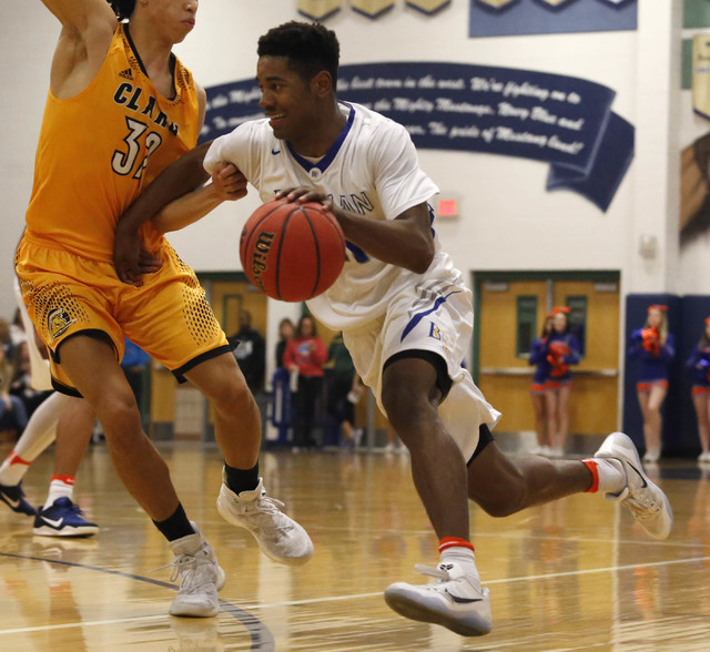 Bishop Gorman’s Ryan Kiley (23) drives the ball pass Clark’s Ian Alexander (32) ...