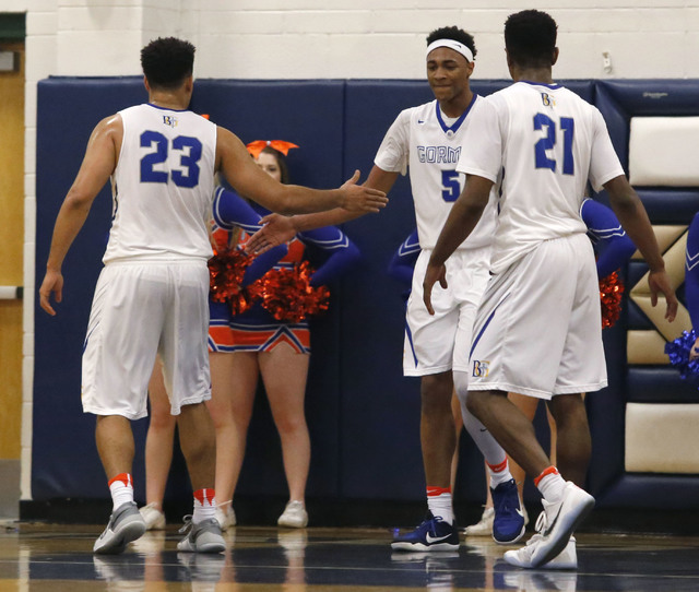 Bishop Gorman’s Chuck O’Bannon (5) claps hands with Bishop Gorman’s Ryan K ...