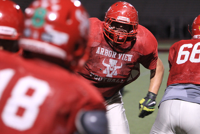 Arbor View tackle Malik Noshi runs a play on defense during practice Wednesday, Nov. 19, 201 ...