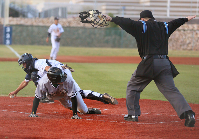 Palo Verde’s Mitchell Rathbun, front left, slides into home plate with the winning run ...