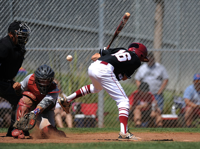 Desert Oasis outfielder Kyle Fuentes is hit by a pitch in the second inning of their prep ba ...