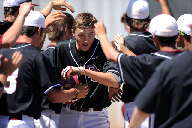 Desert Oasis infielder Brett Brocoff is congratulated by teammates in the dugout after scori ...