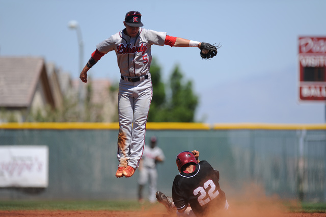 Desert Oasis base runner Nolan Kingham steals second base as Liberty shortstop Nick Rush fie ...