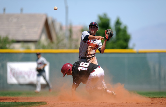 Desert Oasis base runner Kyle Fuentes tries to break up a double play attempt by Liberty sec ...