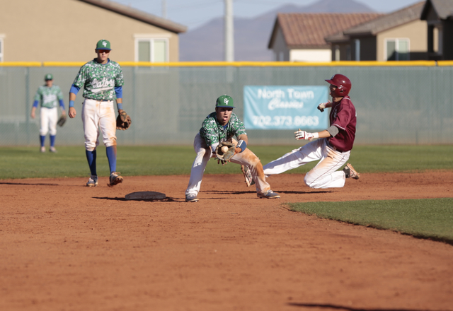 Green Valley sophomore A.J. Amelburu (4) catches a throw to second but misses the tag of Des ...