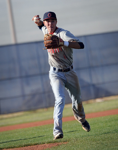 Coronado third baseman Tanner Bellamy sets up to throw the ball to first base during a game ...