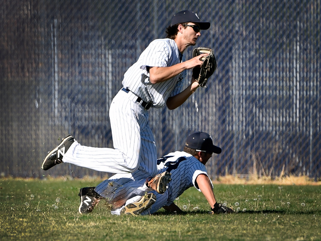 Spring Valley’s Carter Lambeth, left, trips over teammate Nick Rupp after catching a f ...