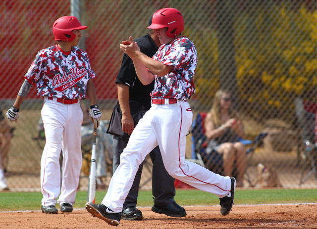 Arbor View’s Sam Pastrone celebrates after scoring a run against Faith Lutheran on Sat ...