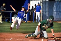 Basic’s Roger Riley (3) slides home as Green Valley catcher Ty Burger collects the bal ...