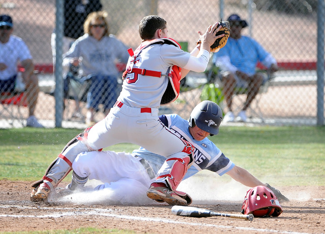 Foothill’s Ryan Moyes is tagged out by Liberty catcher Nick Rush as he slides into hom ...