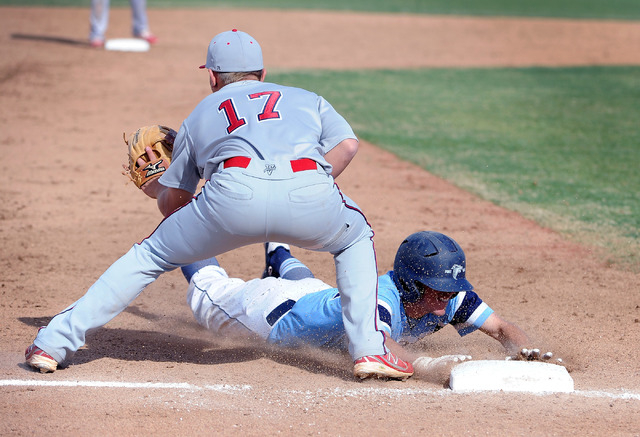 Foothill’s Daniel Hauck slides safely into third base as Liberty’s Josh McCollum ...
