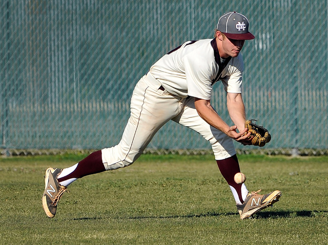 Cimarron-Memorial right fielder Adam Mitchell drops a pop fly on Monday against Bishop Gorma ...