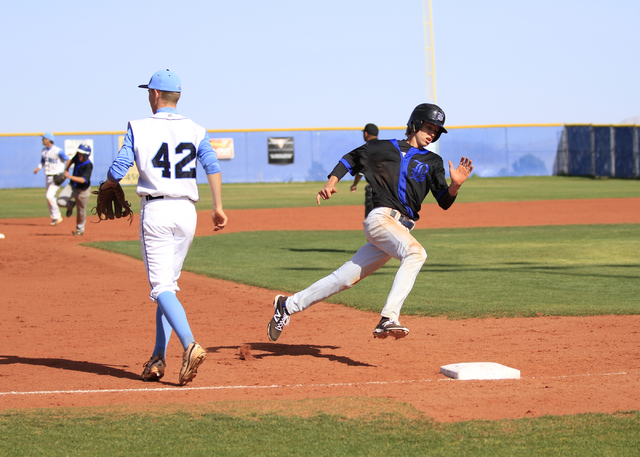 Basic High School junior David Hudleson (5) heads around third base on the way to home plate ...