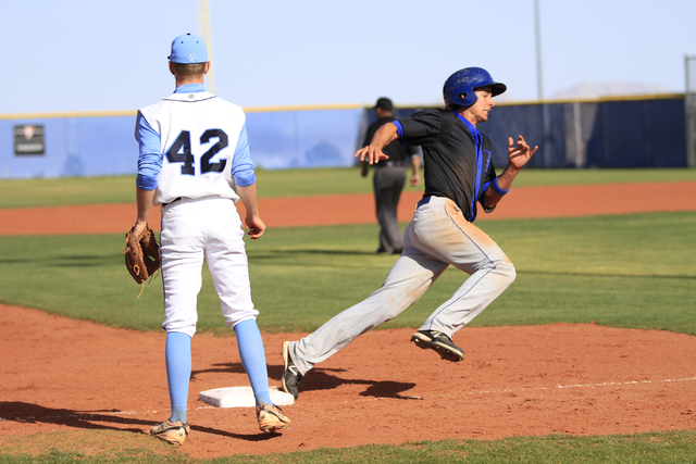 Basic High School senior Logan Green (4) rounds third base on his way to home during a game ...