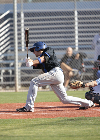 Basic High School senior Logan Green (4) connects on his swing during a game against Centenn ...