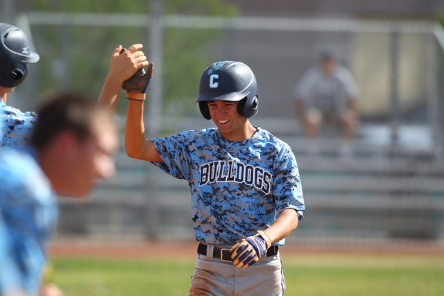 Centennial’s Tanner Wright celebrates with teammates in the first inning after scoring ...