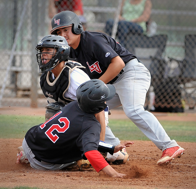 Shadow Ridge catcher Robbie Galvan attempts to tag out Las Vegas’ Kyle Christensen (12 ...