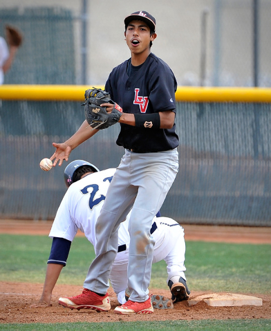 Las Vegas first baseman Eddie Ojeda smiles the WilShadow Ridge’s Antonio Arreola durin ...